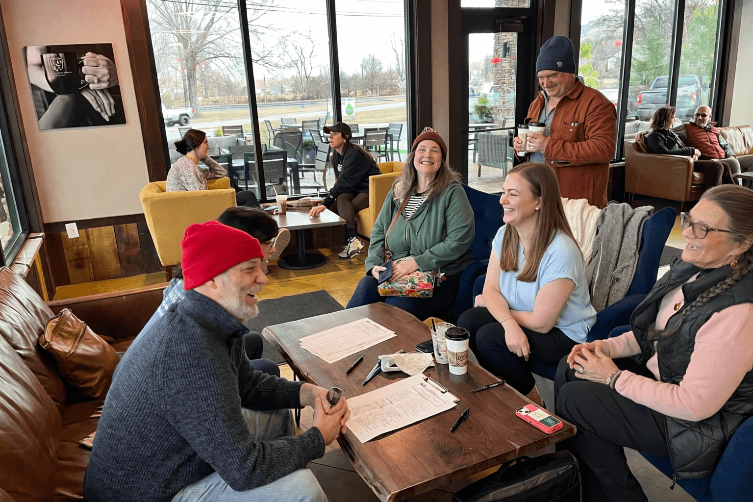 Ruth Walker and community members gathered in conversation at a local coffee shop during campaign event